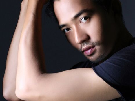 Captivating close-up of a man's thoughtful, intense gaze in a studio setting.