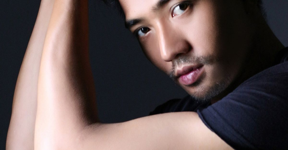 Captivating close-up of a man's thoughtful, intense gaze in a studio setting.