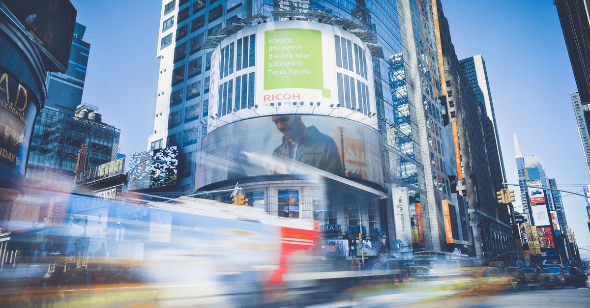Dynamic capture of Times Square showcasing bustling city life and traffic in New York City.