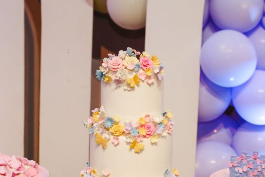 A beautifully decorated cake featuring pastel floral designs, perfect for celebrations and parties.