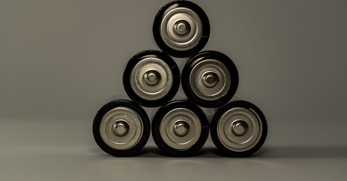 Metallic AA batteries stacked in a pyramid shape, symbolizing power and energy storage.
