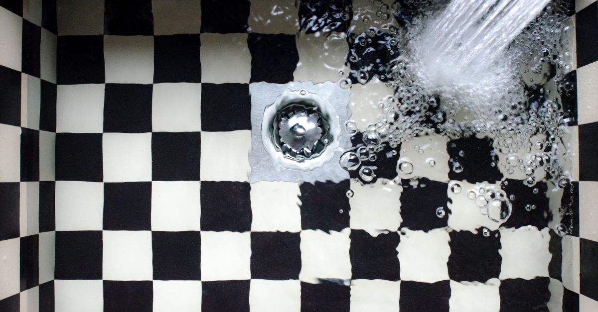 Top view of a checkered sink with water splashing, showcasing elegant design.