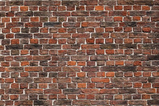 Close-up of a red brick wall displaying rustic texture and pattern, ideal for background use.