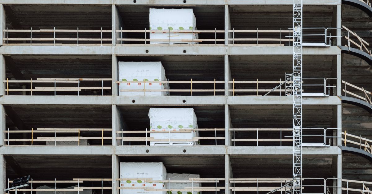 Close-up of a multi-storey building under construction, showcasing steel and concrete structure.