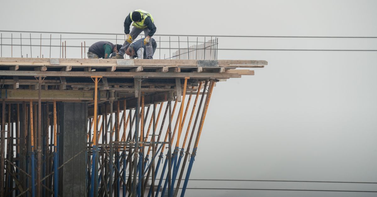 Workers on a high-rise building construction site in Denizli, Türkiye, showcasing teamwork and safety.