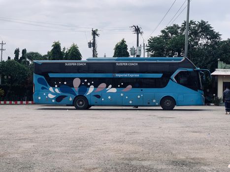 Side view of Imperial Express sleeper coach bus in Dhaka, Bangladesh.