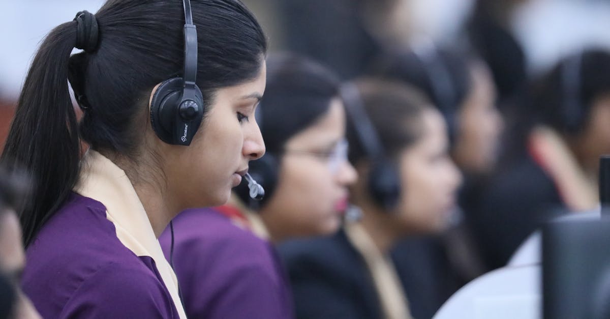 Call center agents wearing headsets working in a focused office environment.