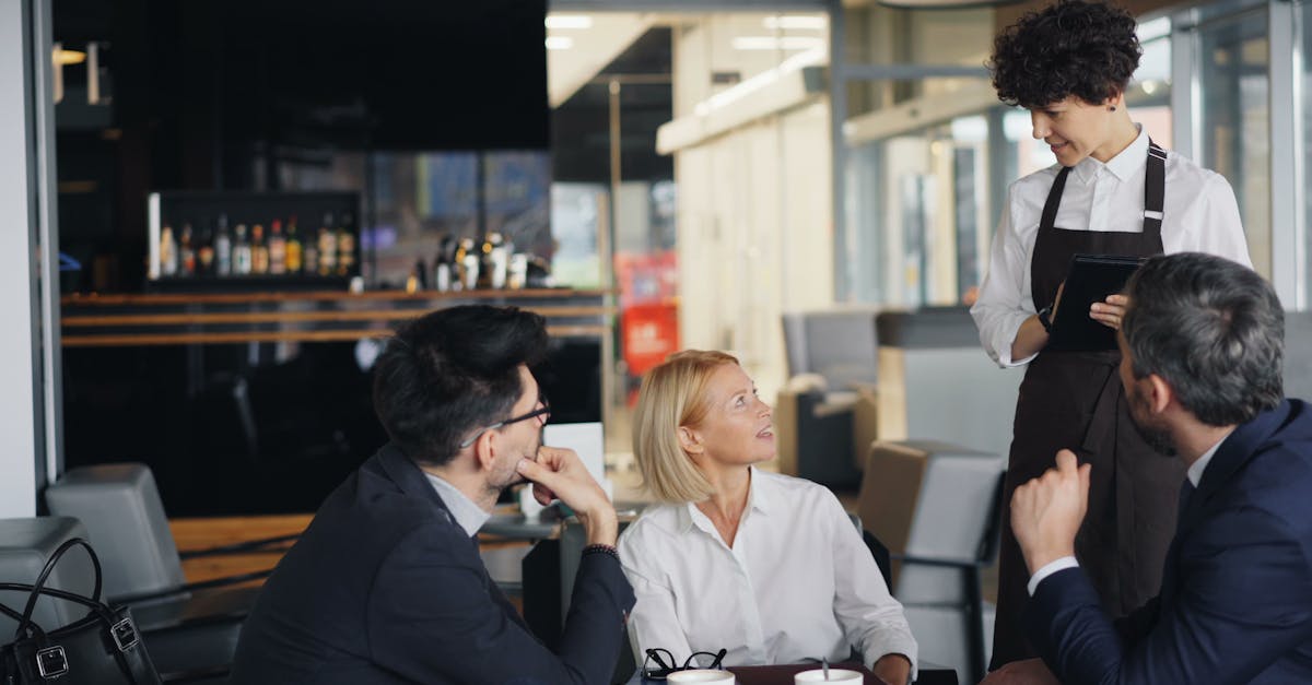 Professionals meeting in a modern cafe with attentive waitress service.