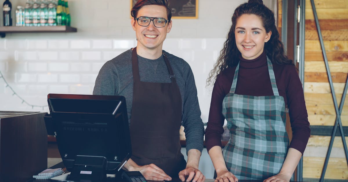 Cafe staff smiling at the counter, ready to assist customers.