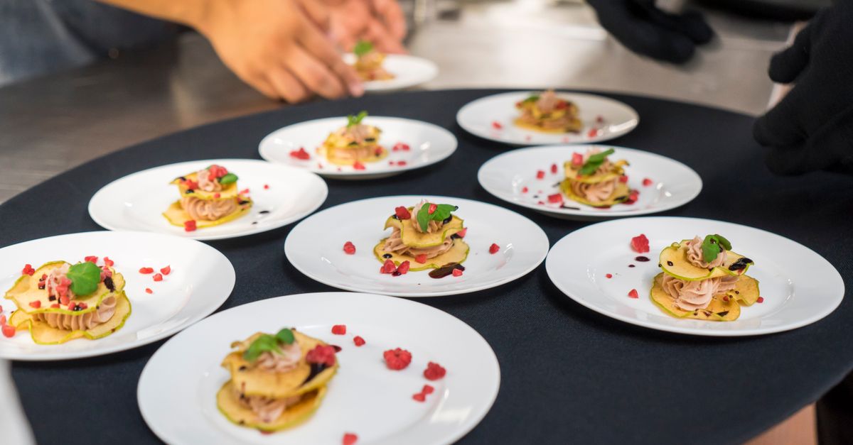 A chef's creative presentation of gourmet appetizers on elegant plates. Shot from above.