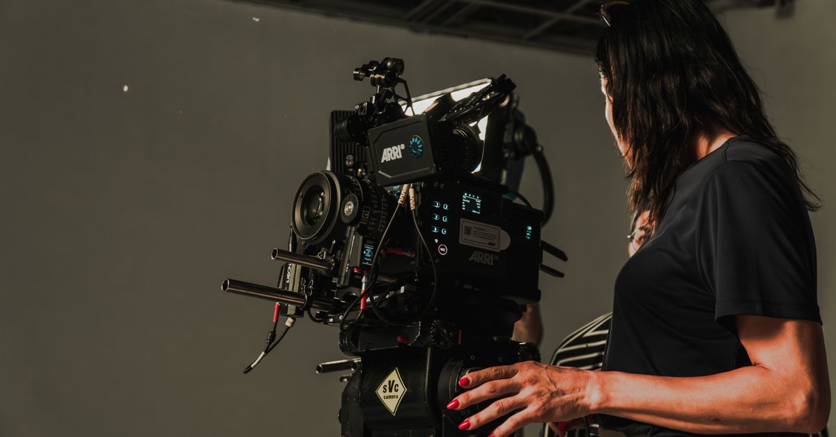 Close-up of a film crew operating a camera rig in a studio, capturing a cinematic production.