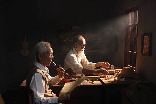 Artisans crafting violins in a traditional Jakarta workshop with natural light.
