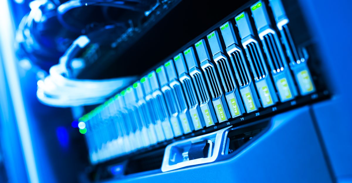 A detailed view of a blue lit computer server rack in a data center showcasing technology and hardware.