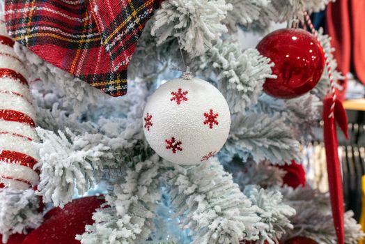 Close-up of a decorated Christmas tree with red and white ornaments, perfect for holiday decor.