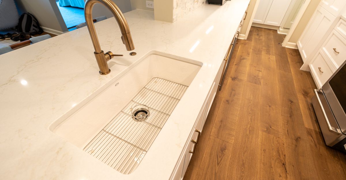 A clean, modern kitchen featuring a marble countertop and sleek fixtures, perfect for culinary inspiration.