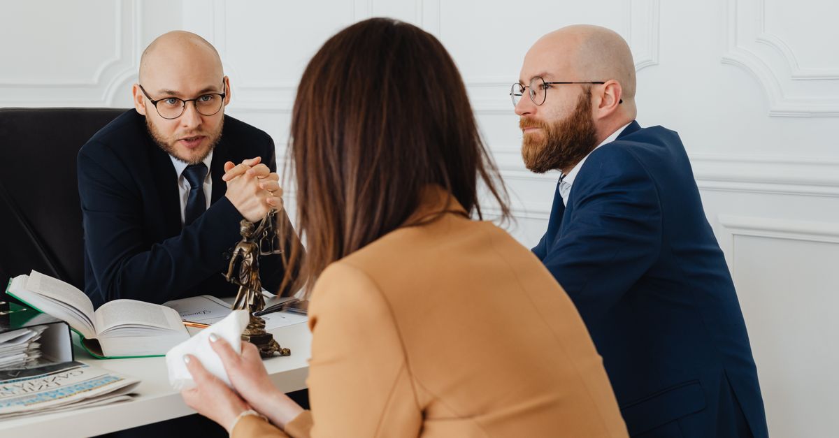 Professional discussion among lawyers in a modern office, focusing on legal matters.