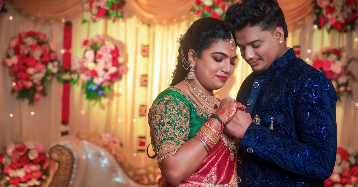 A joyful Indian couple in traditional attire during their wedding ceremony in Chennai.
