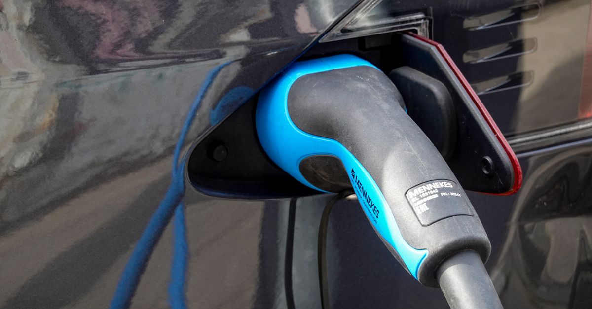 Close-up of an electric vehicle being charged using a Mennekes EV connector.