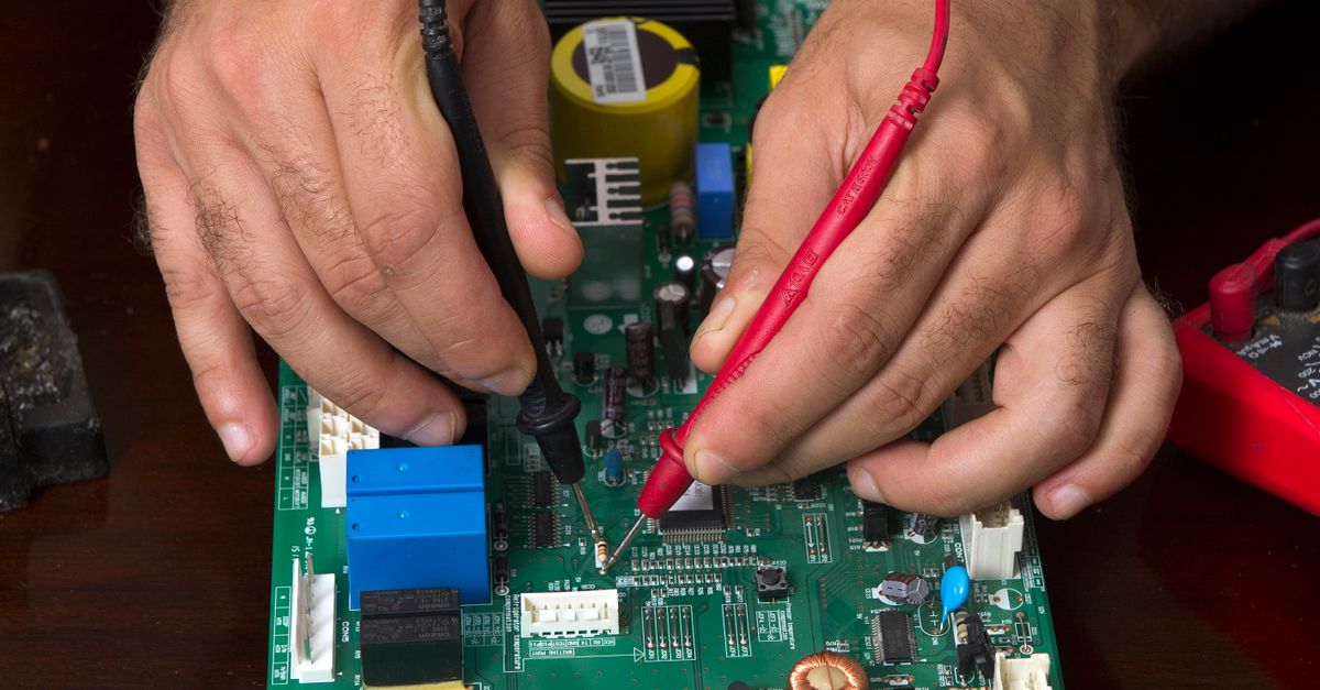 A detailed view of hands working on a circuit board using probes, depicting precision and electronics repair.