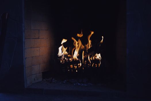 A close-up of a warm, inviting fireplace with flickering flames, perfect for a cozy interior setting.