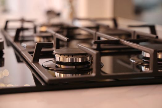 Close-up of a modern stainless steel gas stove top, ideal for contemporary kitchens and cooking environments.
