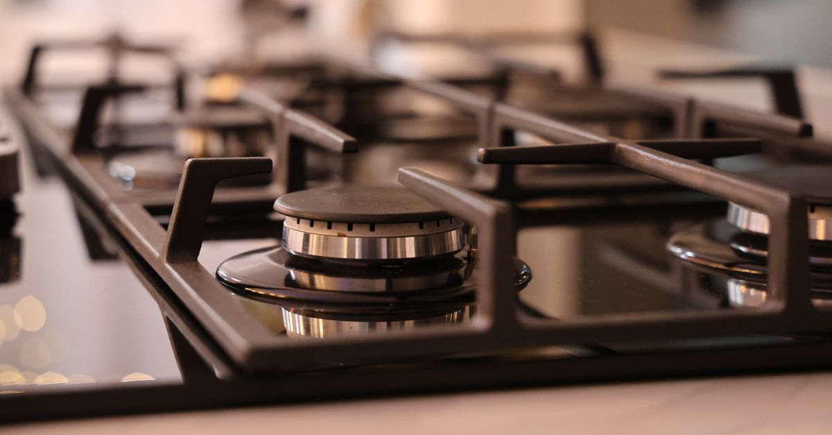 Close-up of a modern stainless steel gas stove top, ideal for contemporary kitchens and cooking environments.