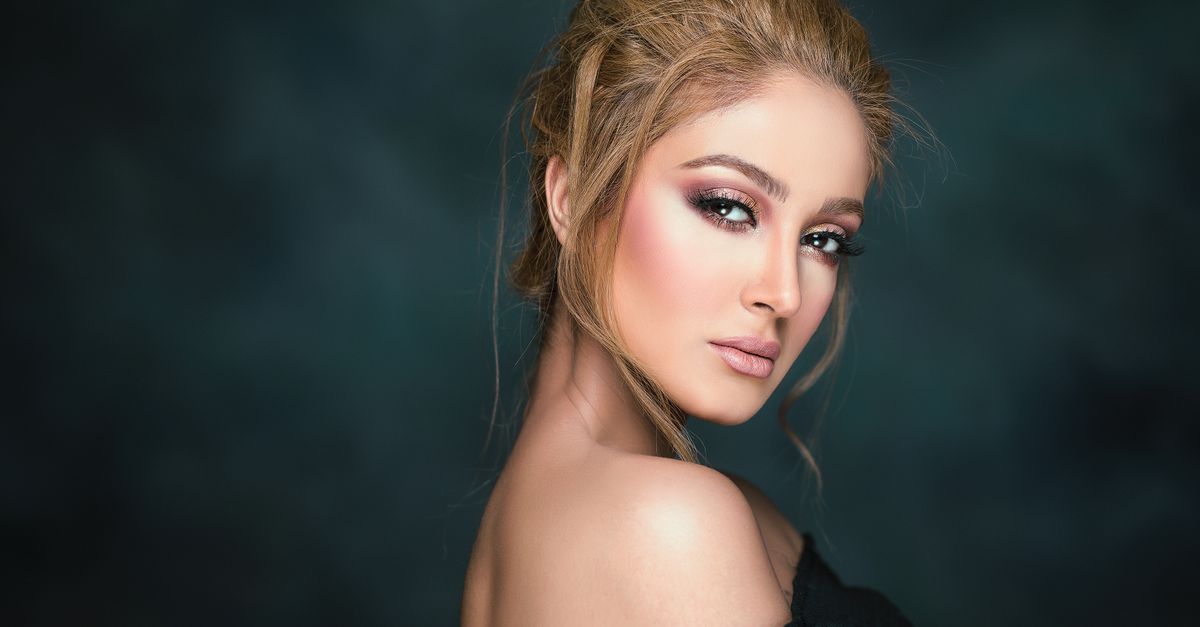 Stunning portrait of a glamorous woman showcasing elegant makeup and hairstyle.