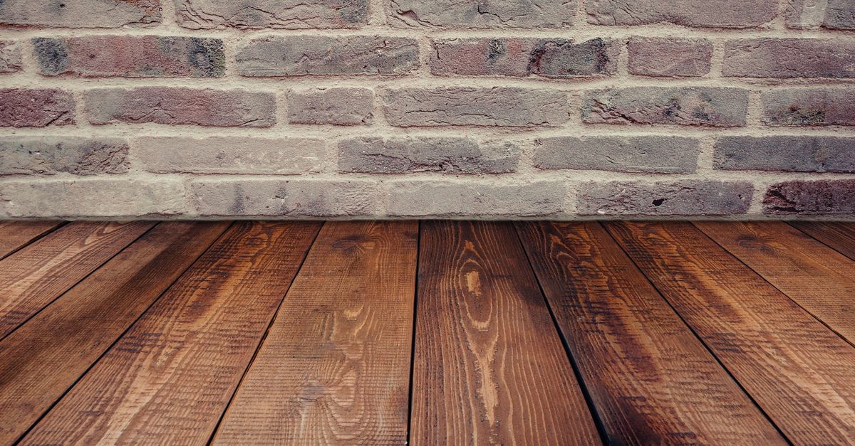 Stylish vintage brick wall background complemented by a rustic wooden floor.