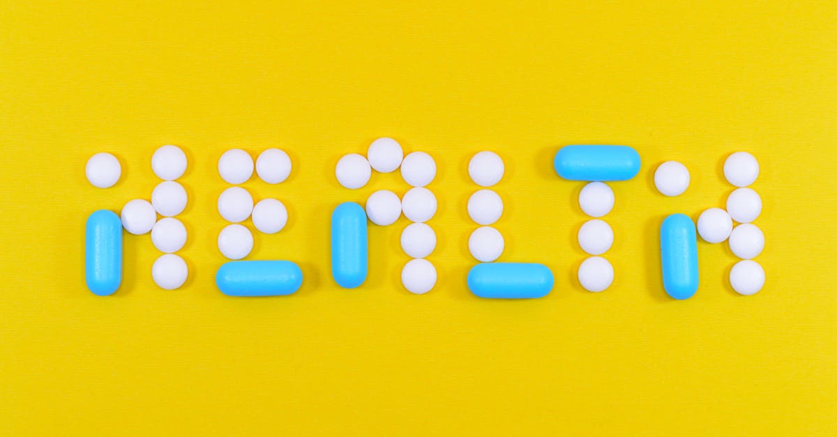 Pills spelling 'health' on a vibrant yellow background, symbolizing wellness.