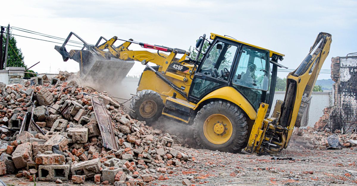 Excavator removing rubble at a demolition site in Maseru, Lesotho.