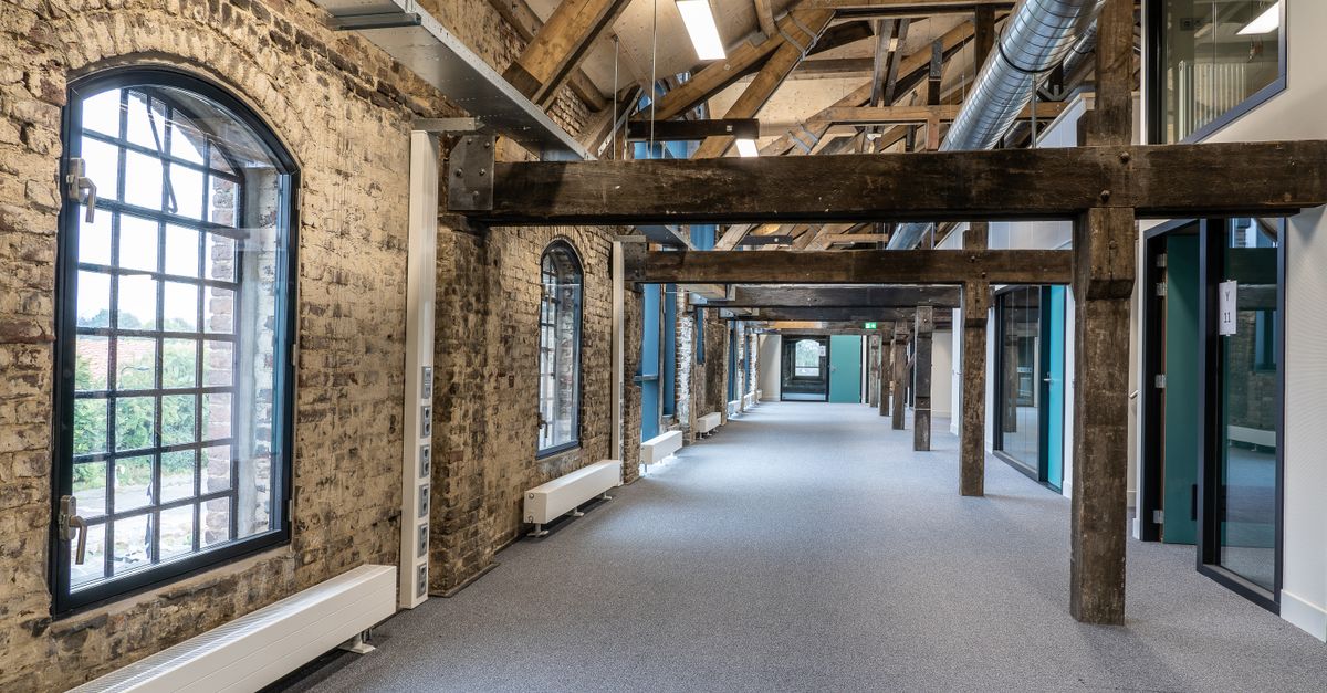 A stylish fusion of modern and rustic in a spacious office hallway interior.