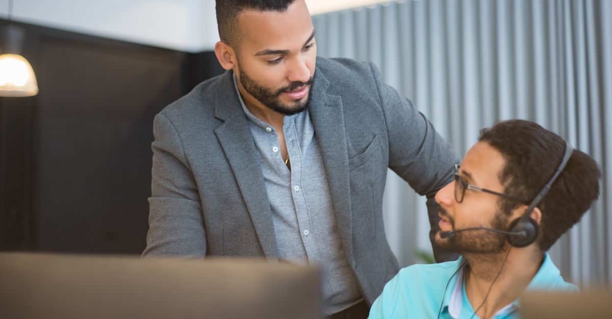 Two men collaborating in an office environment, fostering teamwork.