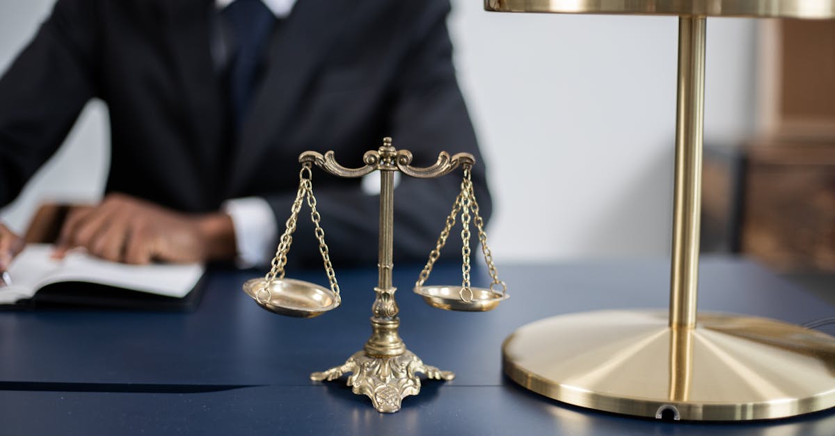 Elegant legal office with a close-up of golden scales of justice on a sleek dark desk.