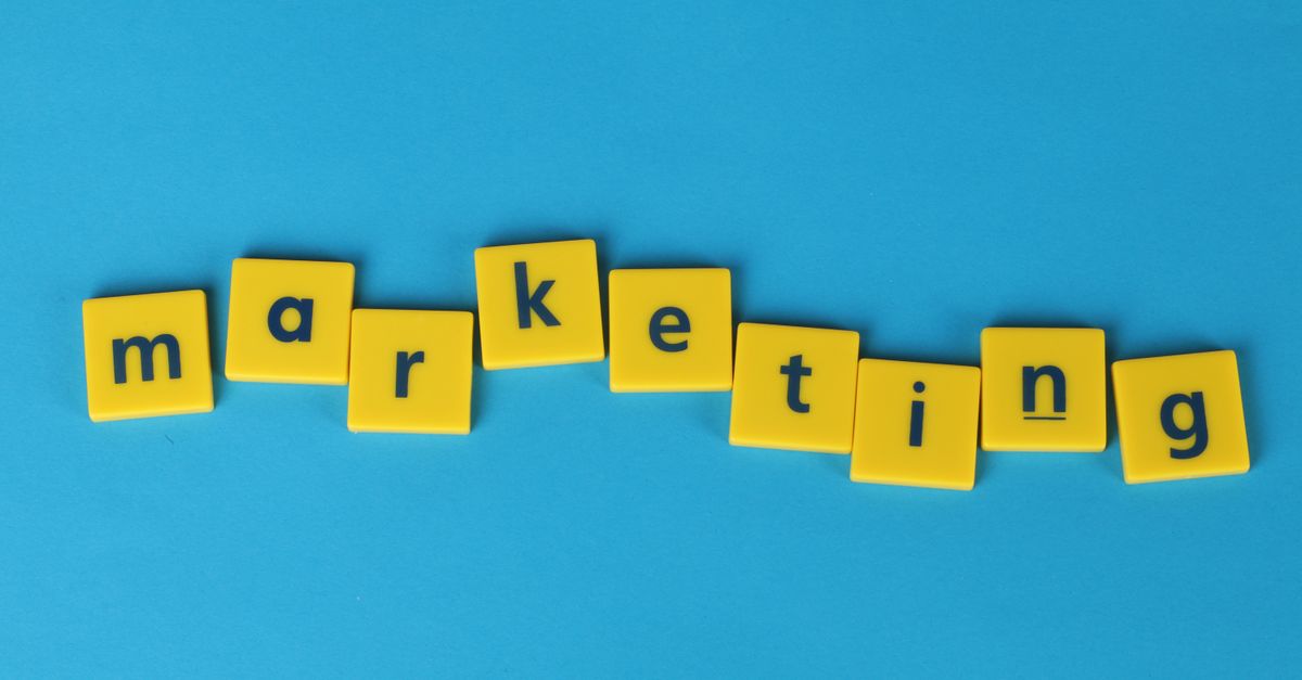 Bright yellow tiles spelling 'marketing' on a blue background, ideal for business themes.