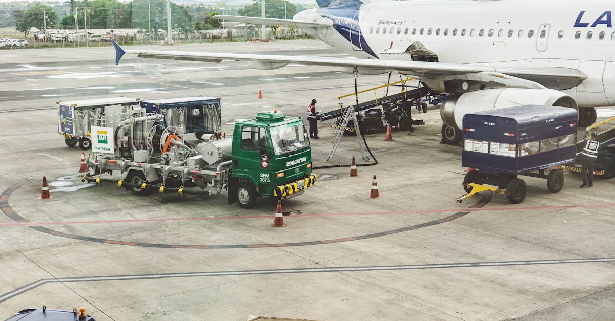 Ground support services in action at an airport terminal with visible aircraft and service vehicles.
