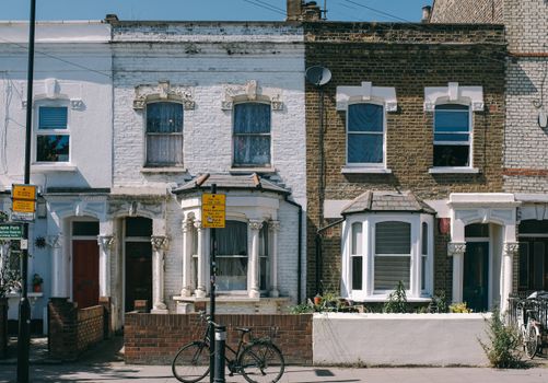 Charming vintage brick facades on a typical residential street in London, United Kingdom.
