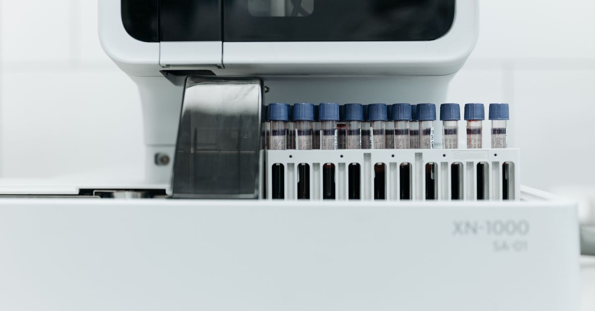 Close-up of laboratory machine holding test tubes for analysis.