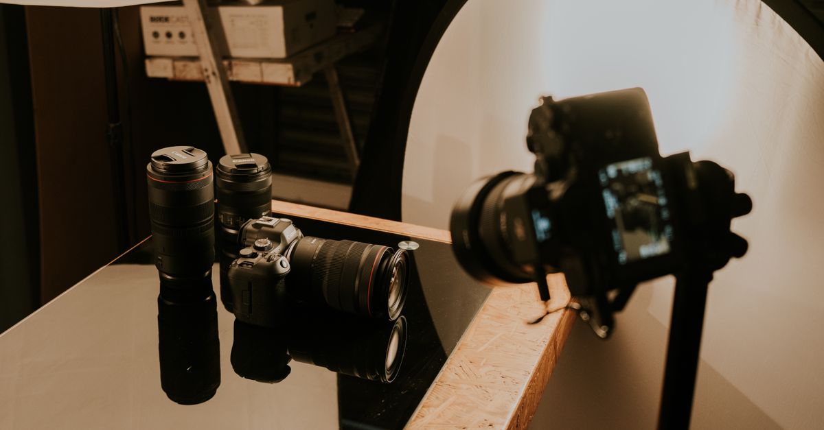 A detailed view of a professional camera setup with lenses and lighting in a studio environment.
