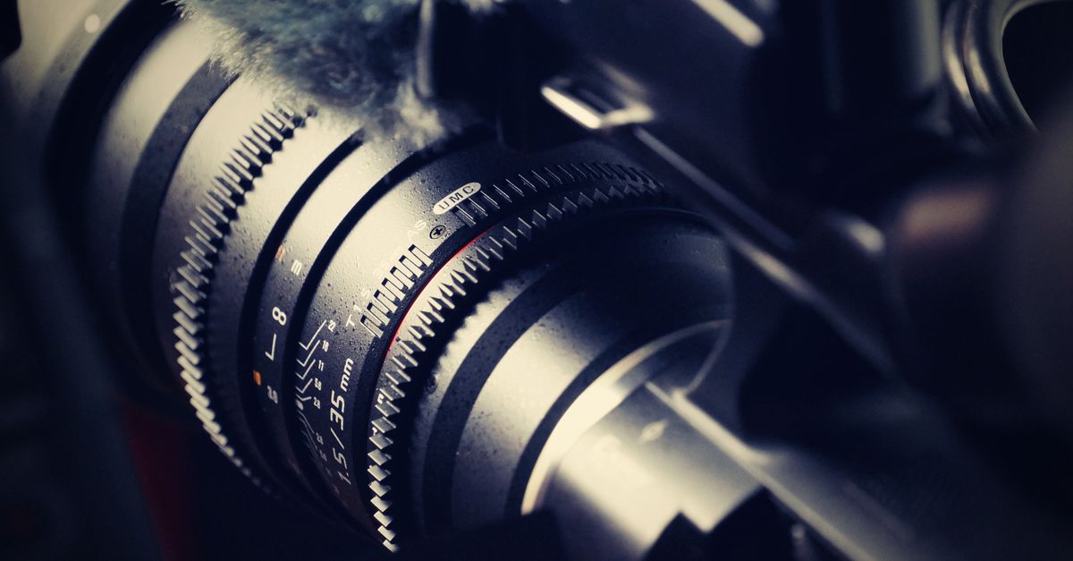 Detailed macro shot of a professional camera lens, showcasing its intricate design and mechanical precision.