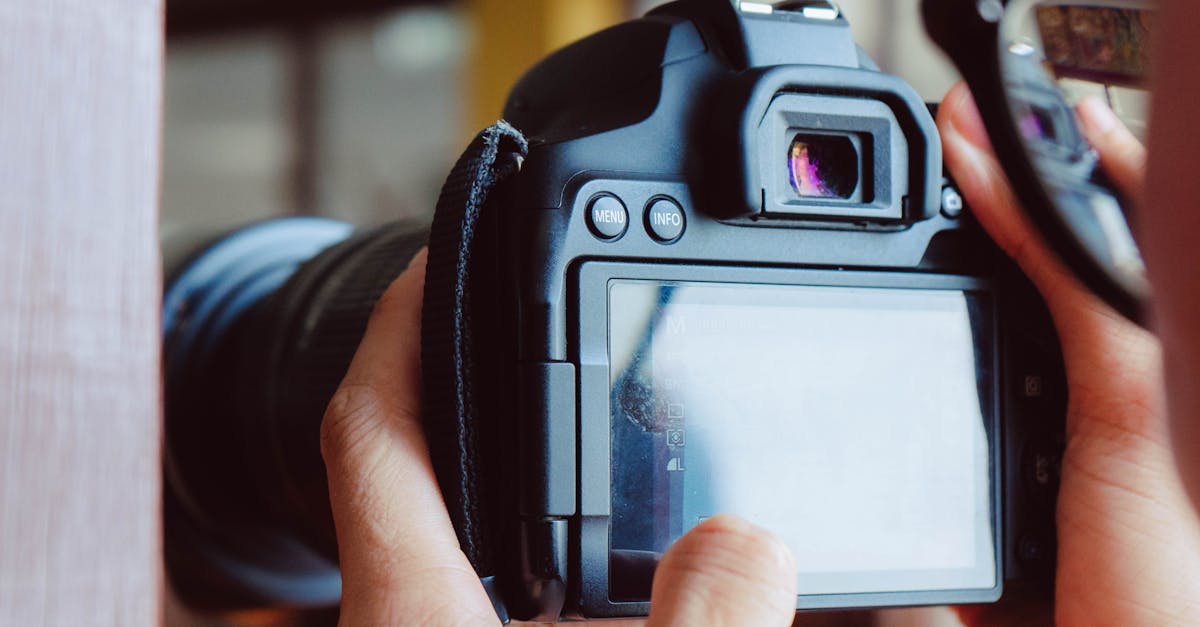Detailed view of hands operating a DSLR camera in Bangkok, Thailand.