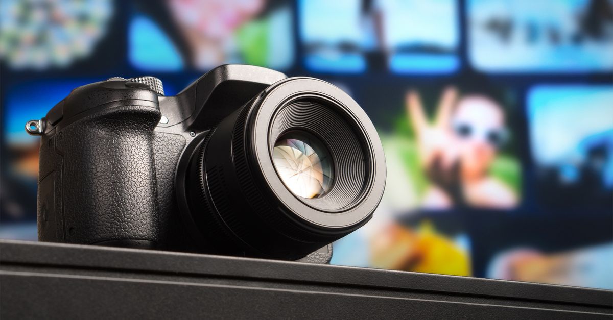 Close-up view of a DSLR camera lens with visible aperture and blurred background.