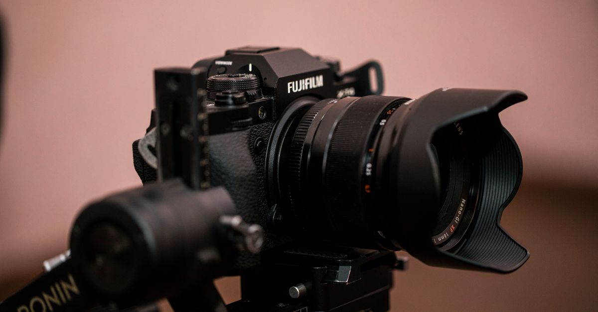 Close-up of a Fujifilm camera mounted on a Ronin gimbal, showcasing photography gear.