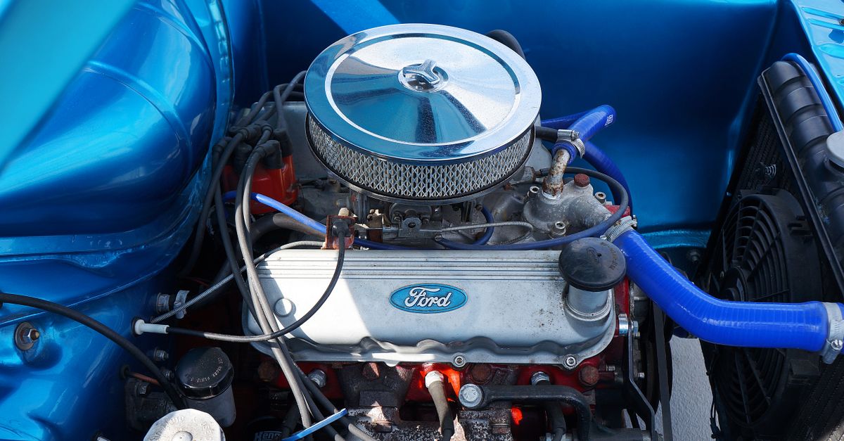Detailed view of a Ford engine featuring blue elements, showcasing automotive engineering and design.