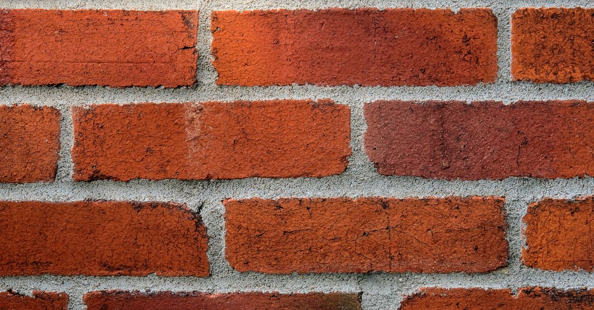 Detailed close-up of a red brick wall showing texture and mortar lines.