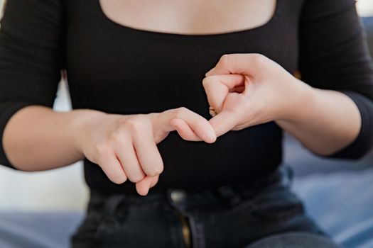 A woman gesturing in sign language, emphasizing non-verbal communication.