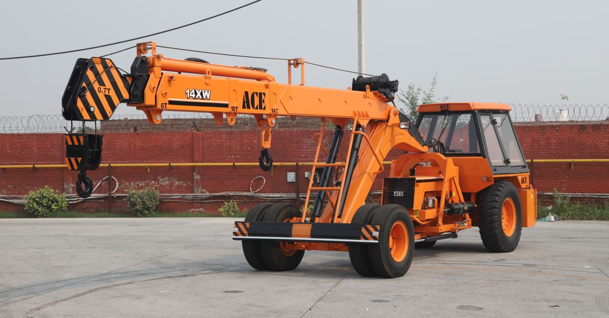 Orange ACE 14XW mobile crane in an industrial outdoor setting in India.