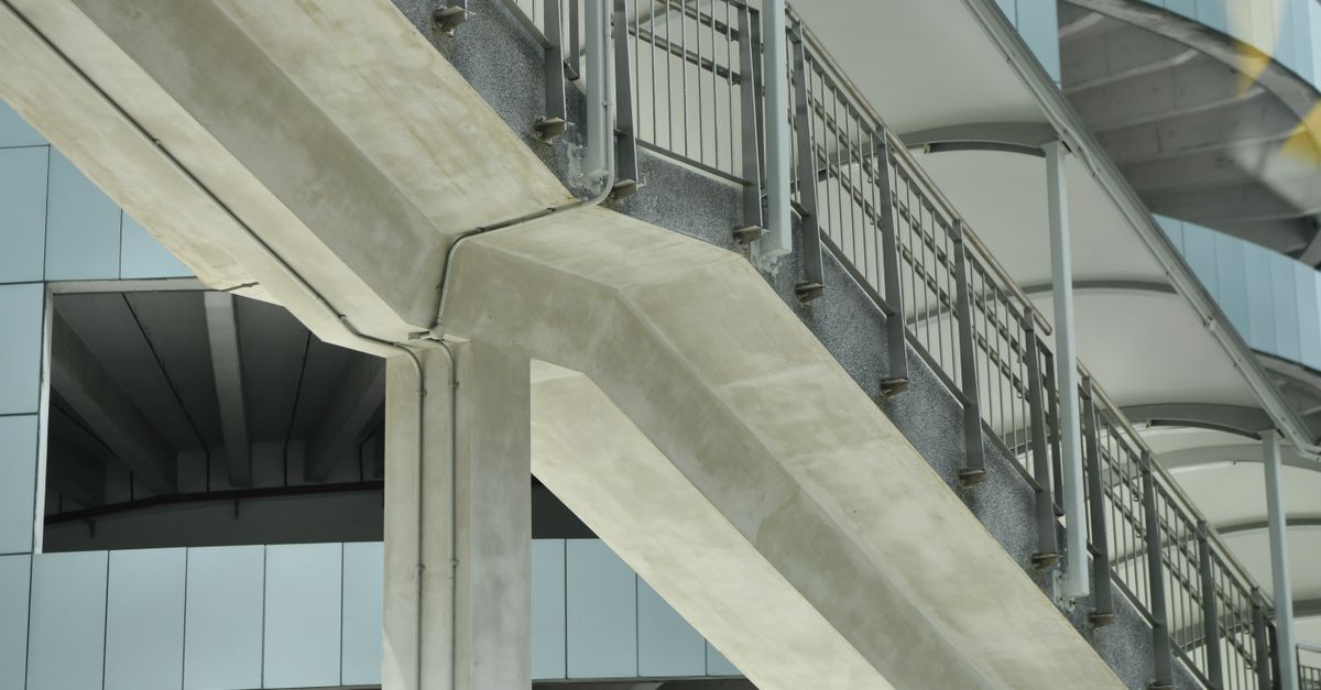Close-up view of concrete and metal urban architecture showcasing geometric design elements.