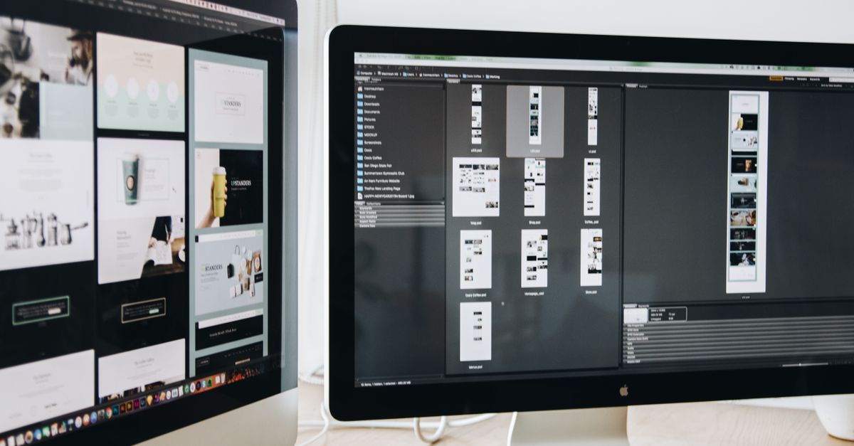 A modern workspace featuring dual computer monitors displaying web design projects, emphasizing technology and productivity.