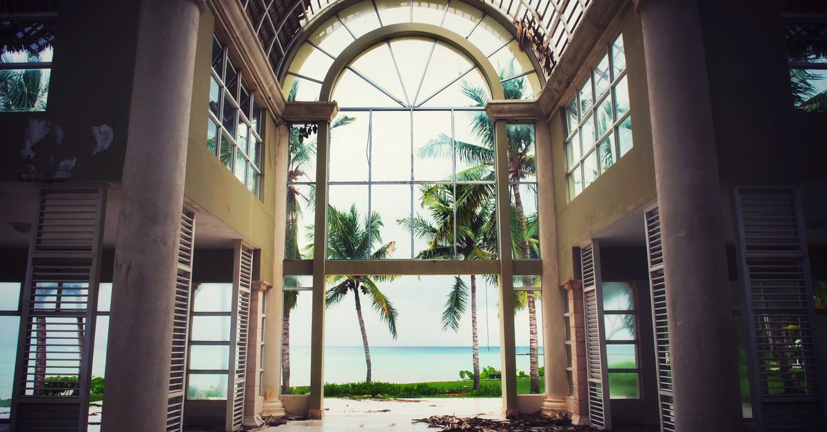 Explore the ruins of an old resort with stunning ocean views in Punta Cana. Captivating scene of decay meets paradise.