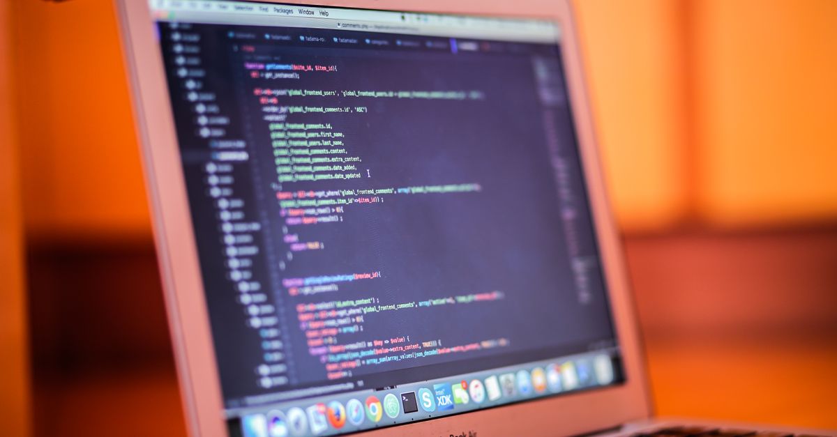 Focused shot of a laptop displaying code, suitable for tech and coding themes.